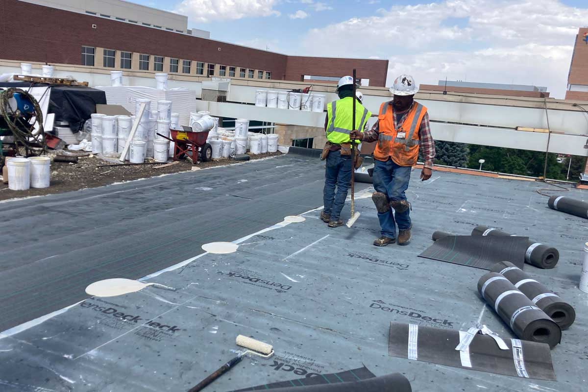 Crew installing Tremco roof underlayment